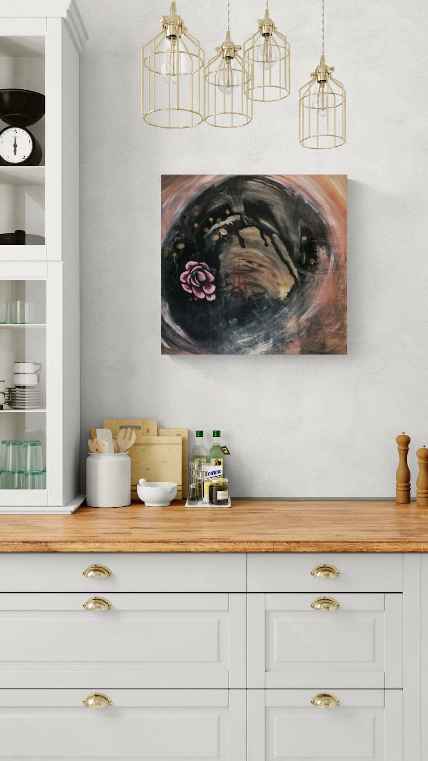 Abstract original meditative pink wall art, titled "Gold Dandelion" by Little Haven Art Studio with a pink flower, gold dandelions, and swirling background hanging above cabinetry in traditional kitchen with wood countertop.