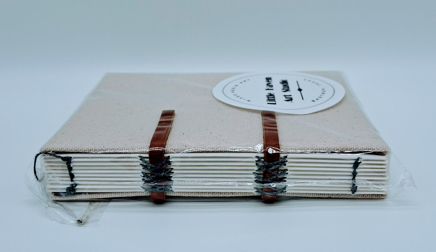 Handmade art journal 6" x 4.5" x 1" with brown canvas cover and gray thread made by Amanda Craig.