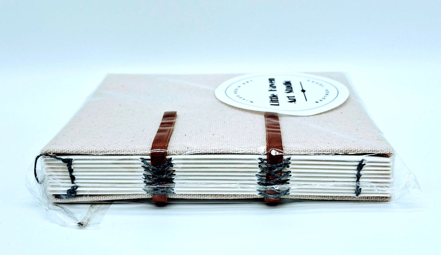 Handmade art journal 6" x 4.5" x 1" with brown canvas cover and gray thread made by Amanda Craig of Little Haven Art Studio.