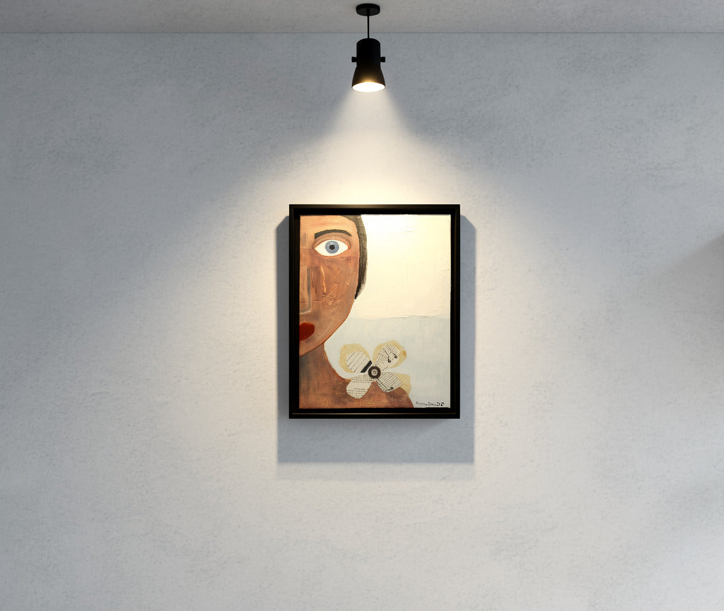 Original mixed media wall art, titled "Sadness" in the Beauty for Ashes series by Little Haven Art Studio, depicting half of a face displaying sad feelings with a tear, with flower collage and plaster elements, hanging under spotlight.
