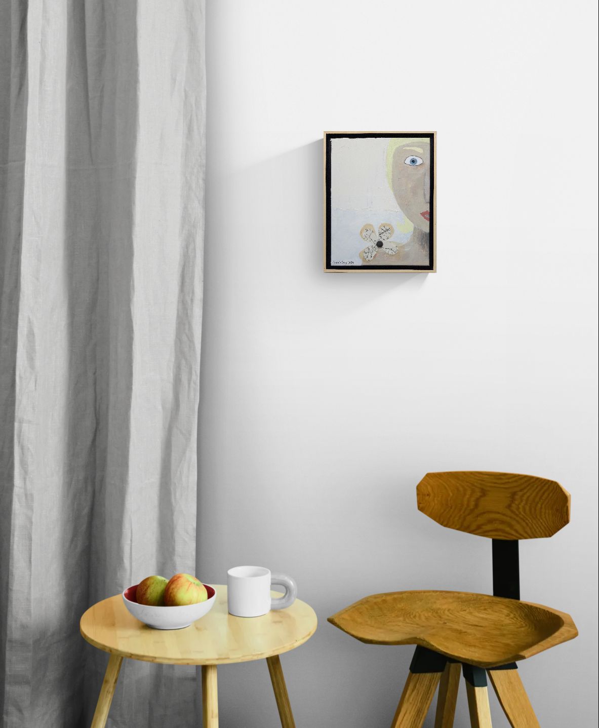 Original mixed media wall art, titled "Shock" in the Beauty for Ashes series by Little Haven Art Studio, depicting half of a face displaying feelings of shock in grief, with flower collage and plaster elements, hanging above wood table and chair.