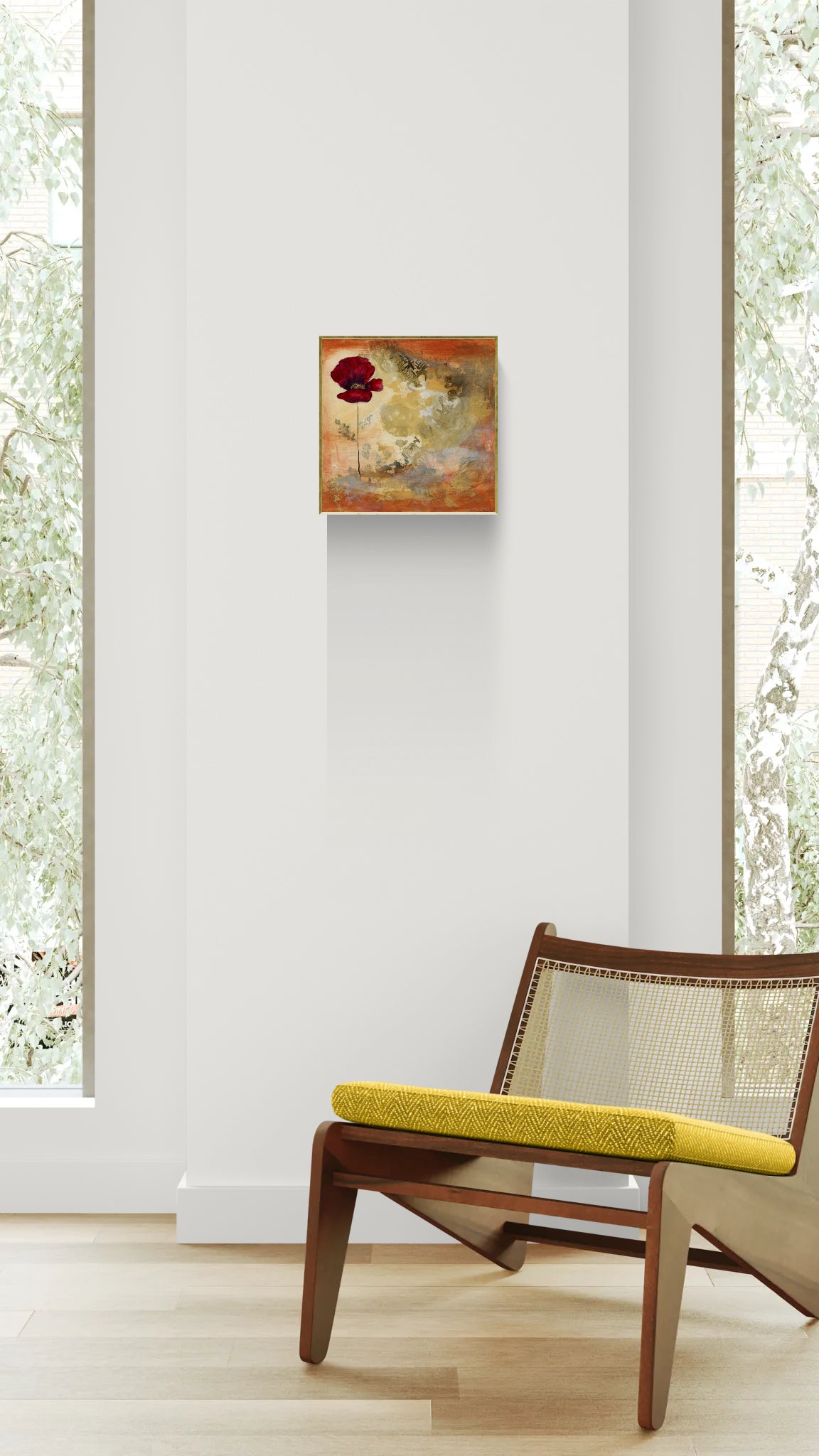 Original floral mixed media painting on abstract background titled, "Eternal Story," by Amanda Craig of Little Haven Art Studio, in amber, gray, umber, and metallic gold, with gold tone floating frame and hanging above mid-century wood chair with yellow cushion.