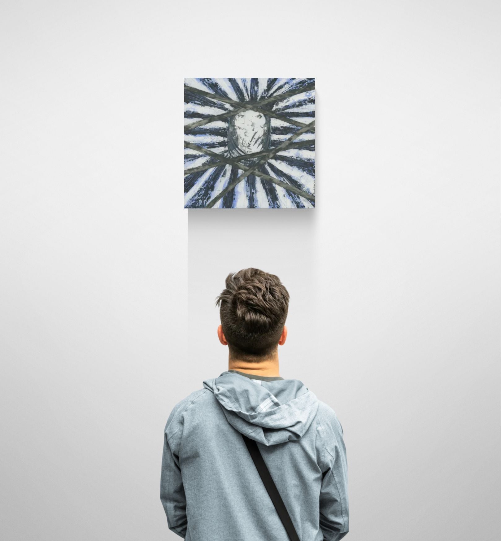 Original meditative blue abstract wall art, titled "Fighting for Freedom" by Little Haven Art Studio, in dark blue, light blue, black, white and depicting a silenced face with hand over mouth in gallery setting with man viewing painting.