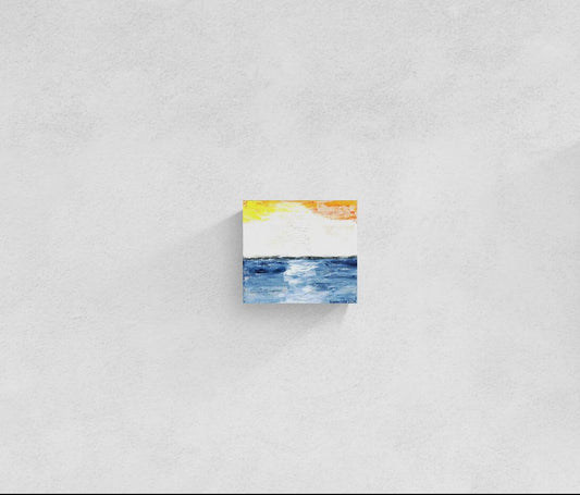 "Glow" is original abstract canvas wall art of a sunset sky over the ocean in orange, yellow, and blue, by Little Haven Art Studio.