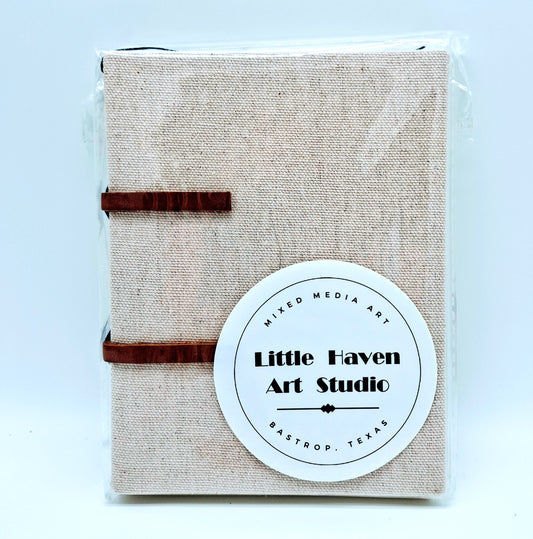 Handmade art journal 6" x 4.5" x 1" with brown canvas cover and blue thread made by Amanda Craig of Little Haven Art Studio.