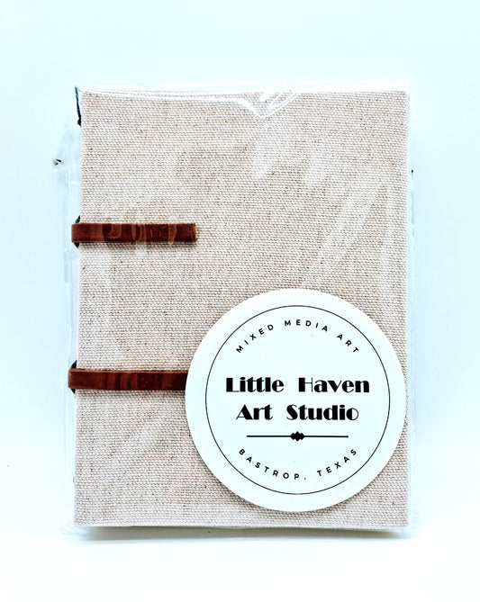 Handmade art journal 6" x 4.5" x 1" with brown canvas cover and gray thread made by Amanda Craig of Little Haven Art Studio.