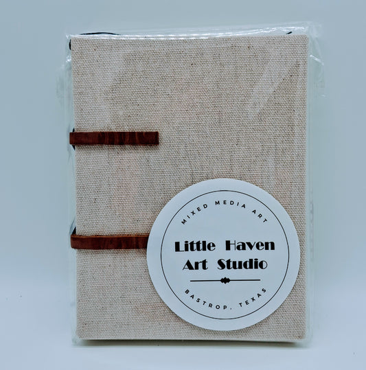 Handmade art journal 6" x 4.5" x 1" with brown canvas cover and blue thread made by Amanda Craig.