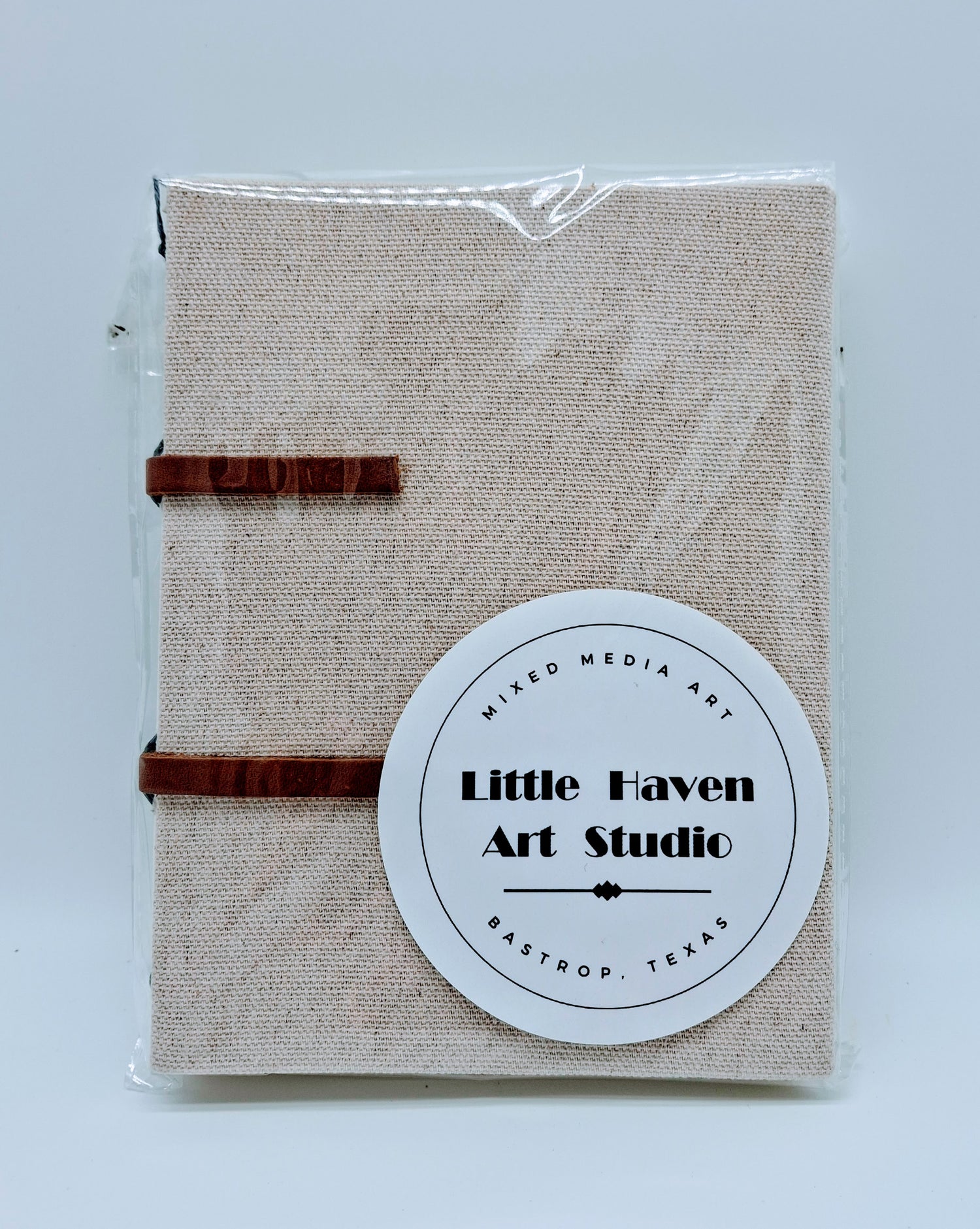 Handmade art journal 6" x 4.5" x 1" with brown canvas cover and gray thread made by Amanda Craig.