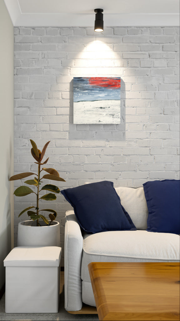 "New Beginnings" abstract original wall art landscape painting with red and blue elements by Little Haven Art Studio hanging in cozy living room corner.