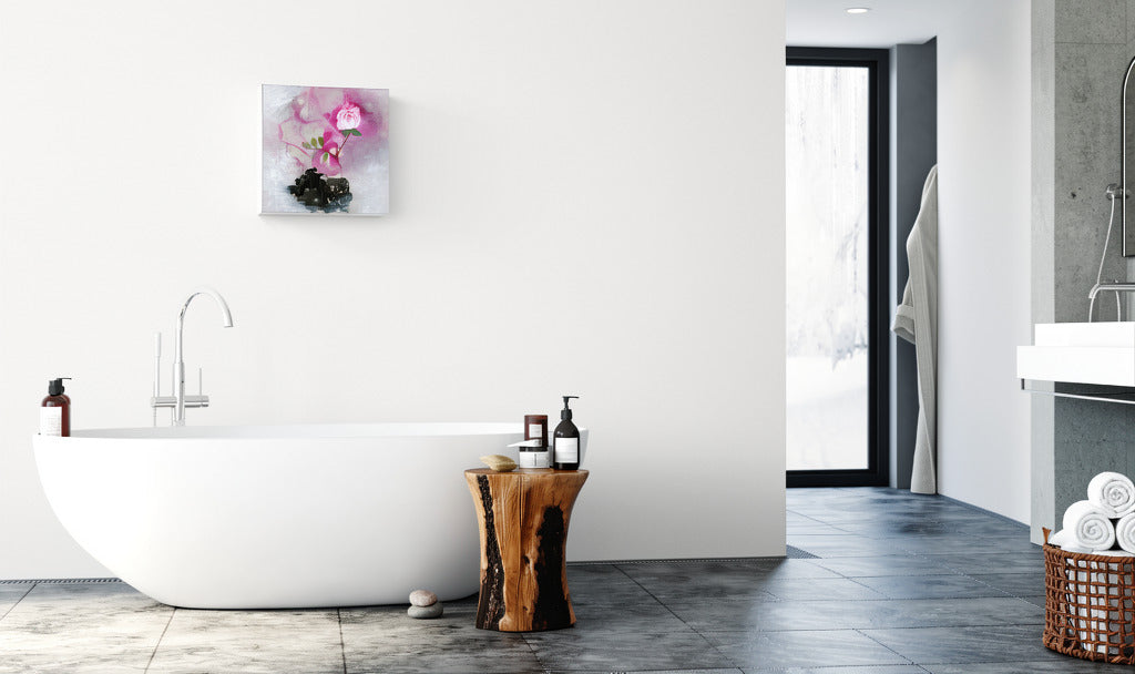 "Sanctuary Bloom" abstract impressionism canvas wall art of a pink rose with green leaves on a textured white and black background by Little Haven Art Studio hanging in bright white bathroom above modern bathtub.