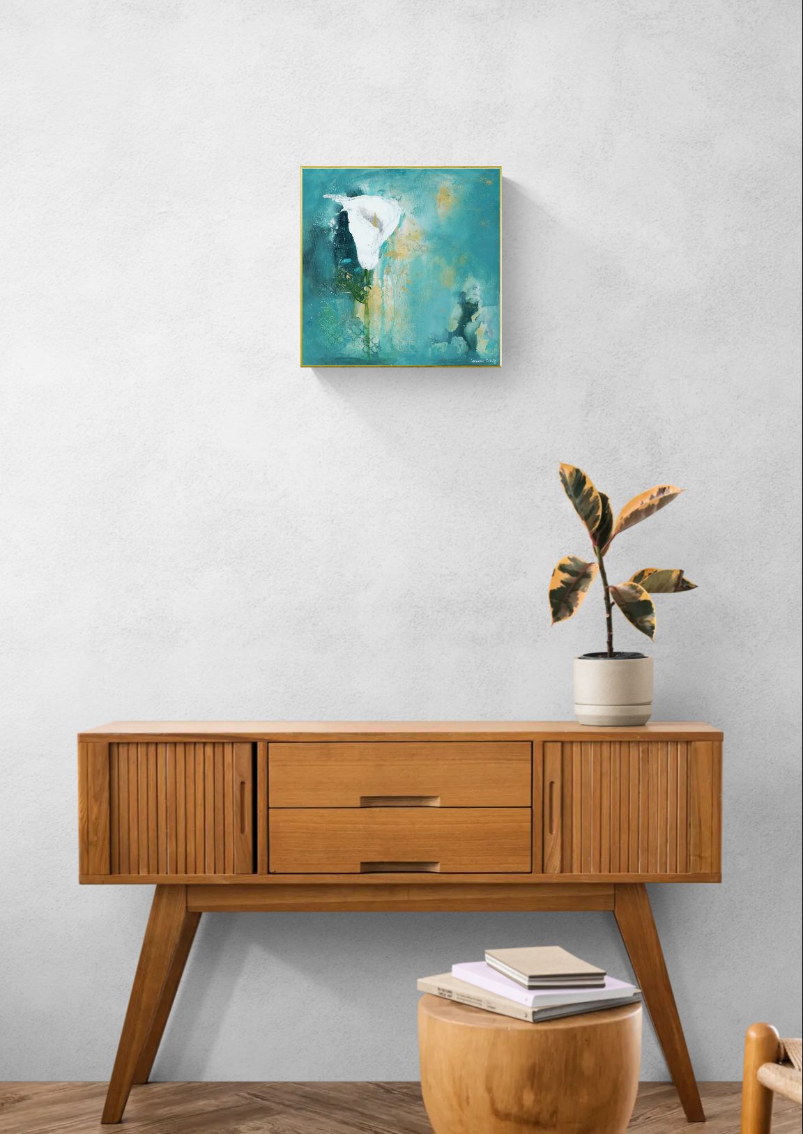 Original floral mixed media painting on abstract background titled, "Steadfast," by Amanda Craig of Little Haven Art Studio, in teal, white, green, and metallic gold, with gold tone floating frame hanging in hallway above wood cabinet with plant.