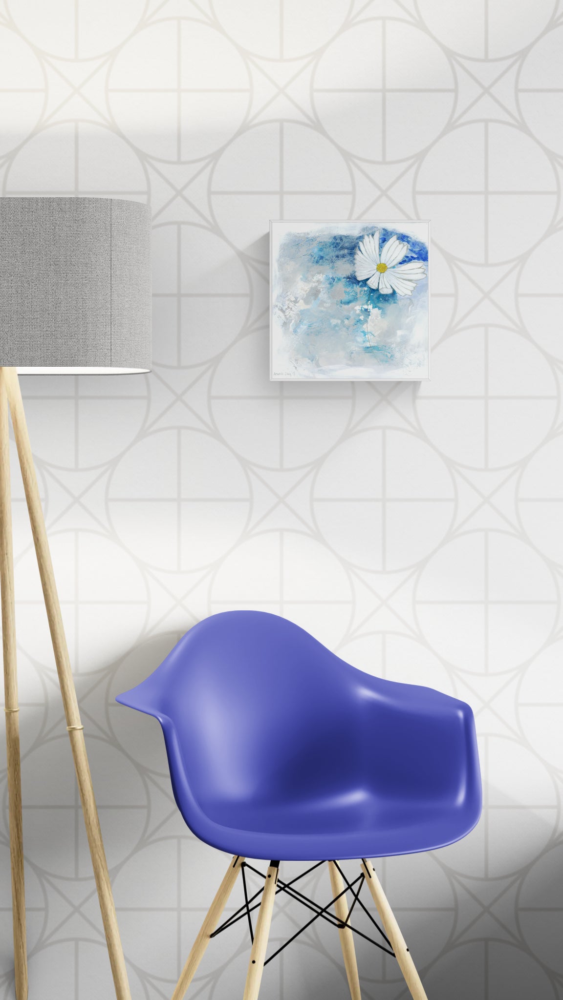 Original floral mixed media painting on abstract background titled, "Stillness," by Amanda Craig of Little Haven Art Studio, in sapphire blue, aqua, bright white, and metallic silver with a silver tone floating frame and hanging above a blue chair with a gray mid-century lamp nearby.