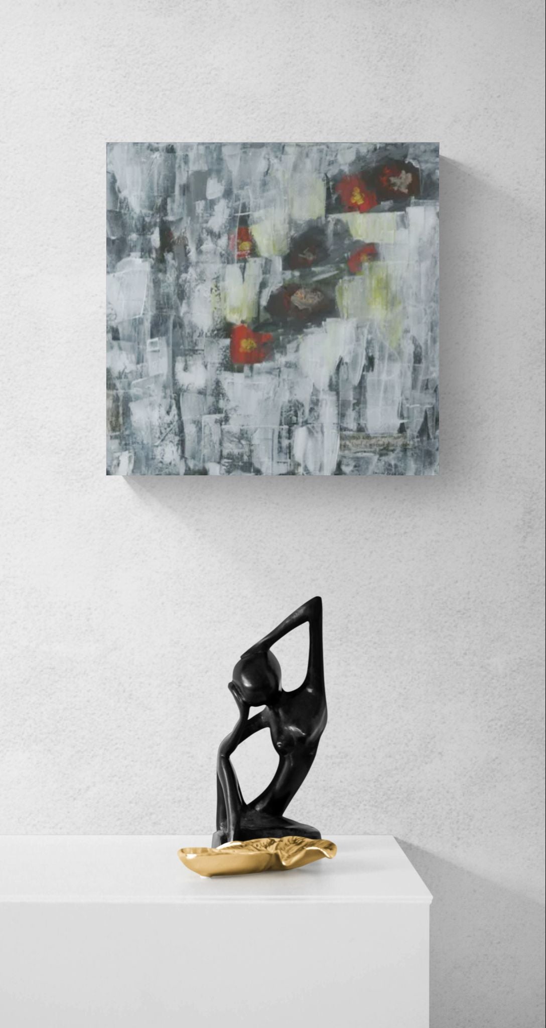 The Flowers Fade original mixed media wall art of abstract red and yellow flowers on gray and white background by Amanda Craig of Little Haven Art Studio, hanging above contemporary art sculpture.