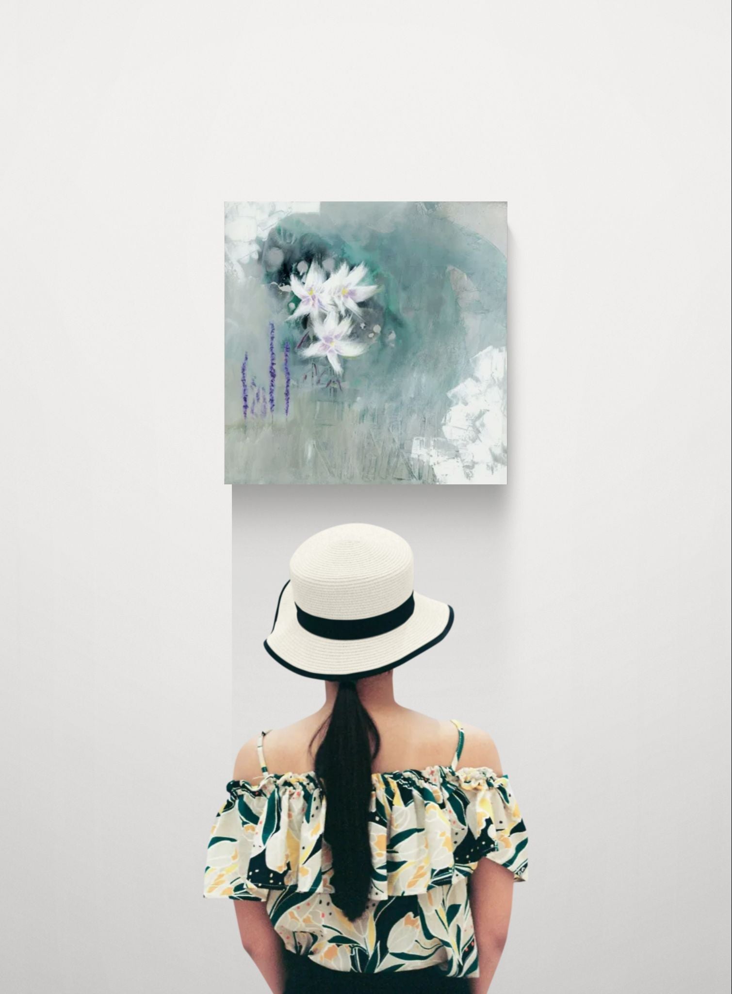 Original dreamy floral abstract impressionism canvas wall art by Little Haven Art Studio in green, purple, linen, gray, white, by Amanda Craig being viewed by a young woman in a dress and hat.